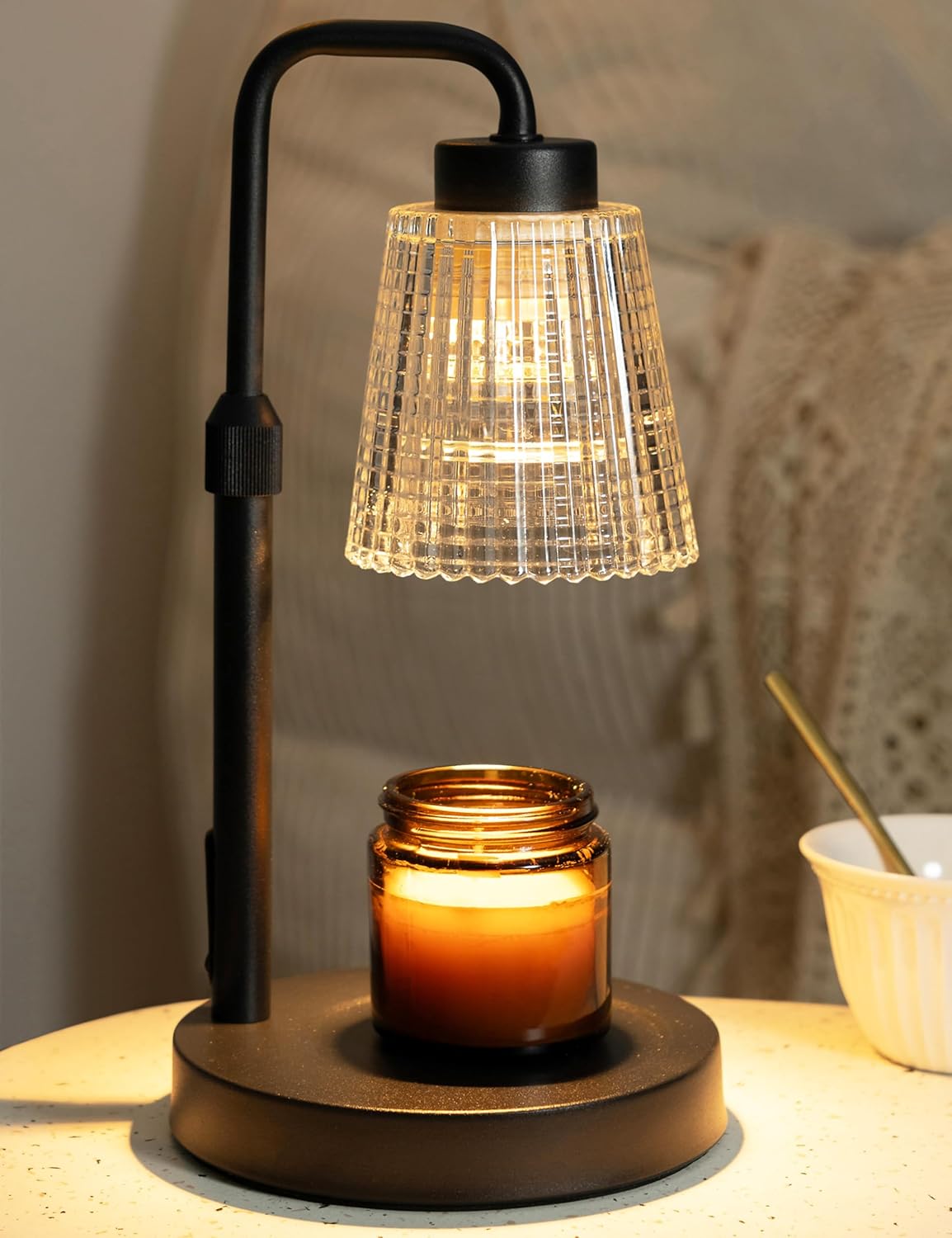 Candle warmer lamp with black arched arm and ribbed glass shade
